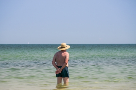 lonely man standing in waterの写真素材