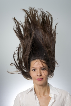 portrait of stylish woman with her hair flowing over her headの写真素材
