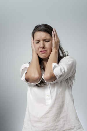 woman with headache and negative face expressionの写真素材