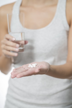 Woman displaying tablets on her palmの写真素材