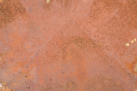 Background texture of an old painted wall with weathered brown paint and a rough surface