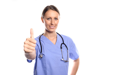 Happy woman doctor giving a thumbs up gesture to show that surgery or treatment of a patient has been successful and there is hope for a full recovery, isolated on whiteの写真素材