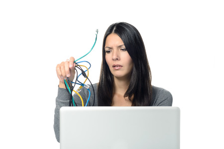 Close up of Upset Woman in Gray Long Sleeve Shirt holding Tangled Network Cables in Her Hand While Experiencing computer problems, Isolated on White Background.の写真素材