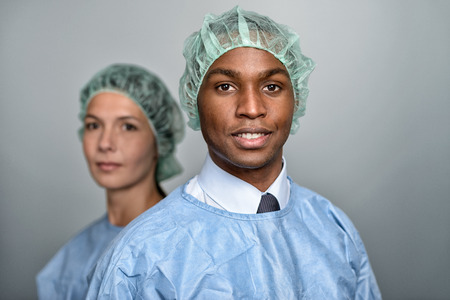 Confident Male and Female Medical Professionals Smiling at the Camera, Isolated on White Background.の写真素材