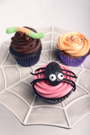 Sweet tasty cupcakes with a spiedeer decoration for halloweenの写真素材