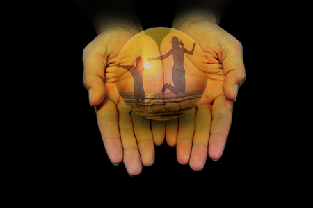 the love of mother and daugther in glass in hand black backgroundの写真素材