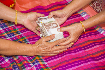 hand old female hold money many thousands bath thaiの写真素材