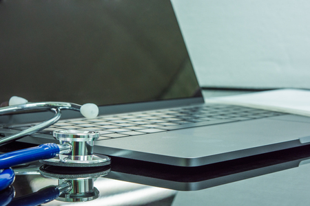 stethoscope near side notebook on the deskの写真素材