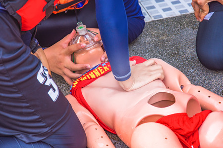 cpr training course and doing chest compression victim arrest drowningの写真素材