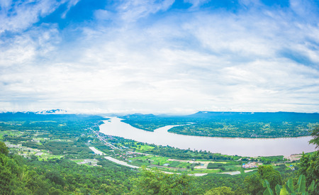 river three line in green tree around on sky blue and white cloudの写真素材