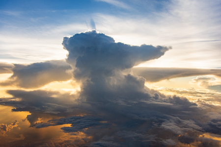 cloud on the blue sky and sun flare back cloudの写真素材