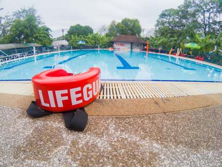 pool lifeguards red rescue tube near swimming poolの写真素材