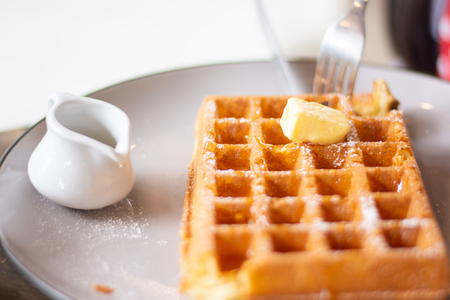 butter on the pancake near white cupの写真素材