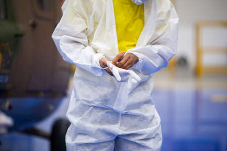 Doctor in PPE uniform wear medical gloves.の写真素材