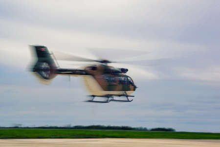 military helicopter  parked at the helipad on run wayの写真素材
