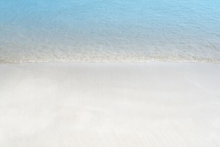 Soft wave of blue ocean on sandy beach. Summer background.