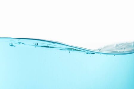 Wave of blue water splash with air bubbles isolated on the white background.の写真素材