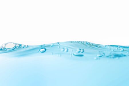 Air bubbles floating on motion wave. Water splash isolated on the white background.の写真素材