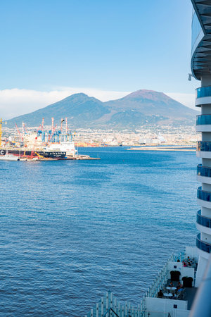 Photograph taken in Naples, Italy, featuring a view of Mount Vesuvius and the sea, captured from a cruise shipの写真素材