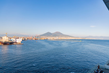 Photograph taken in Naples, Italy, featuring a view of Mount Vesuvius and the sea, captured from a cruise shipの写真素材