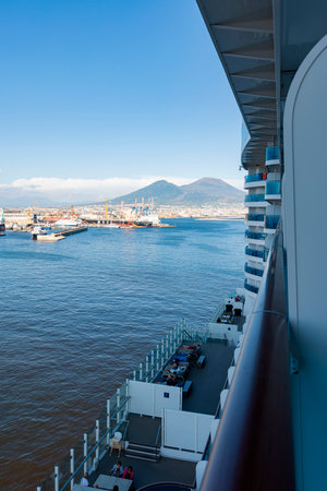 Photograph taken in Naples, Italy, featuring a view of Mount Vesuvius and the sea, captured from a cruise shipの写真素材
