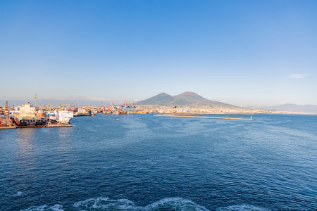 Photograph taken in Naples, Italy, featuring a view of Mount Vesuvius and the sea, captured from a cruise shipの写真素材