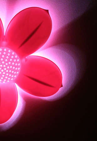 Abstract pink flower light against black backgroundの写真素材