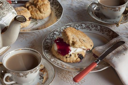 Afternoon tea with cream scone on fine chinaの写真素材