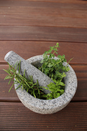 Healthy and fragrant herbs in a stone mortarの写真素材