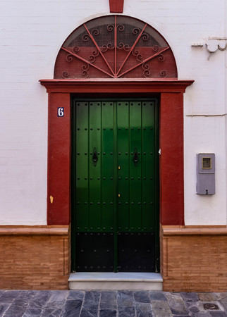 Wooden door inlaid with metal. Entrance in an old European house.のeditorial素材