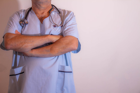 Doctor with arms crossed. Torso of man in medical garments. Adult nurseの写真素材