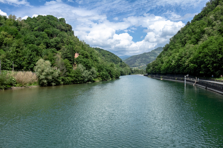 Day with many clouds on a lake of tuscany. Lake surrounded by mountains with intense vegetation.の写真素材