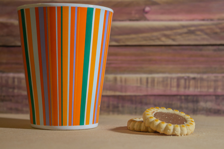Cup of coffee for breakfast. Wooden rustic background. Sweet food for a snack.の写真素材
