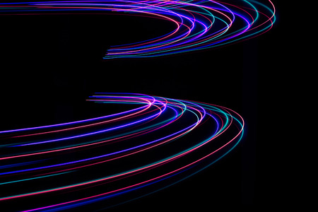 Abstract light lines on black background. Light painting photography. Abstract design with lights in the dark.の写真素材