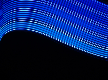 Abstract lines of blue and blue colors on black background.の写真素材