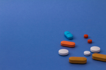 Pills of colors on neutral background. Legal drugs from the pharmaceutical industry. Medicines for...
