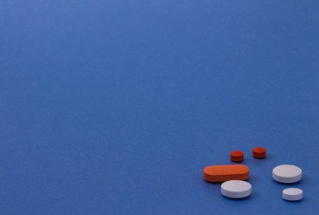 Pills of colors on neutral background. Legal drugs from the pharmaceutical industry. Medicines for...