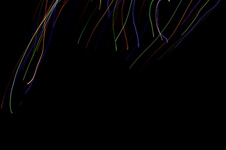Abstract colorful lines on black background. Light painting photography. Lights with irregular...