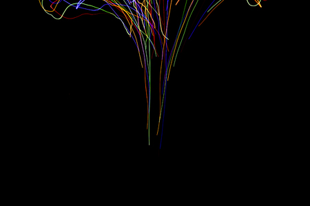Abstract colorful lines on black background. Light painting photography. Lights with irregular...