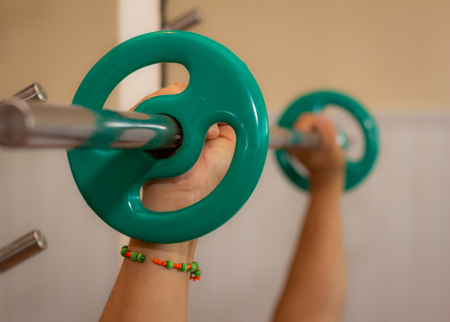 Man exercising in the gym. Exercises to tone muscles. Concept of health care.の写真素材