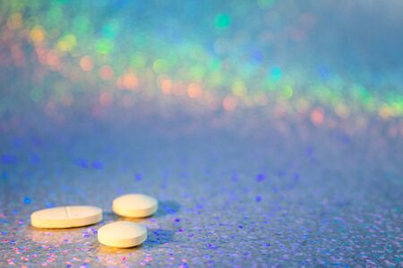 Drug abuse concept. Drugs on colorful background. Party background with colored pills. Drug...