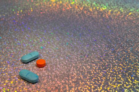 Drug abuse concept. Drugs on colorful background. Party background with colored pills. Drug...