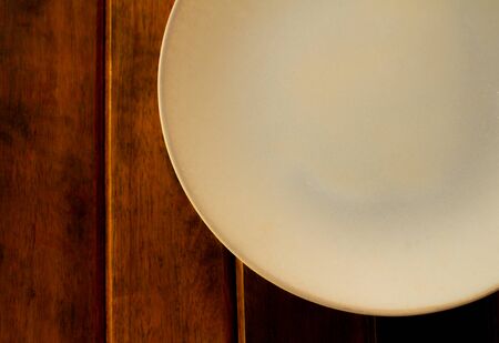 A portion of a plate on a rustic wooden table. Copy Spaceの写真素材