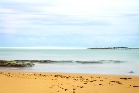 Rocks on the beach. Coastal landscape. Lonely landscape by the sea. Long exposition.の写真素材