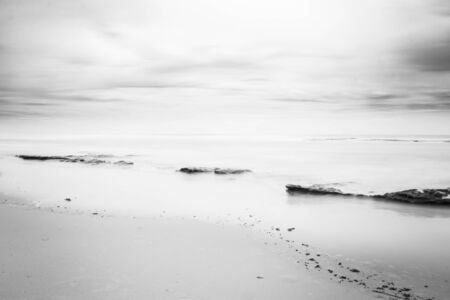 Rocks on the beach. Coastal landscape. Lonely landscape by the sea. Long exposition.の写真素材