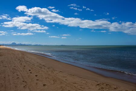 Beautiful desolate beach. No people at the edge of the sea. Coastal landscape.の写真素材
