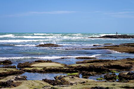 Rocky beach of Brazil. Coral and rock barriers protect the beaches from ocean waves. Daytime photo.の写真素材
