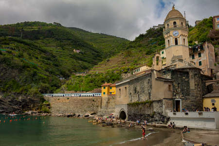 Cinque Terre, Italy. May 15, 2018. Cathedral of the coastal town of northern Italy. Tourists at the...