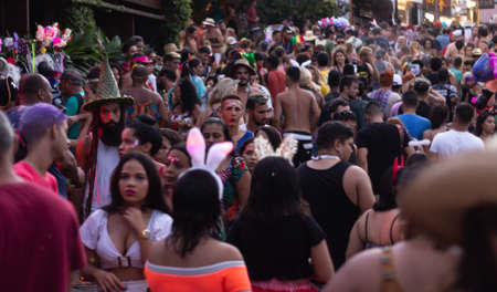 Pipa, Brazil. February 26, 2020. People walk the streets of Pipa celebrating the carnival. A crowd dances in costumes through the streets.のeditorial素材
