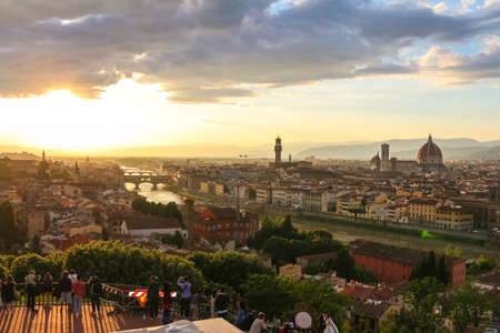 Florence, Italy. May 18, 2016. Sunset in the city of Florence. View of the Arno river and the city. Golden clouds in the sky.のeditorial素材